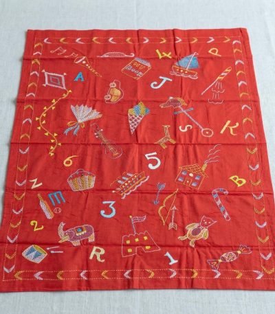 Hand-stitched crimson red baby Nakshi Kantha with alphabet and numbers embroidery by Joyonti